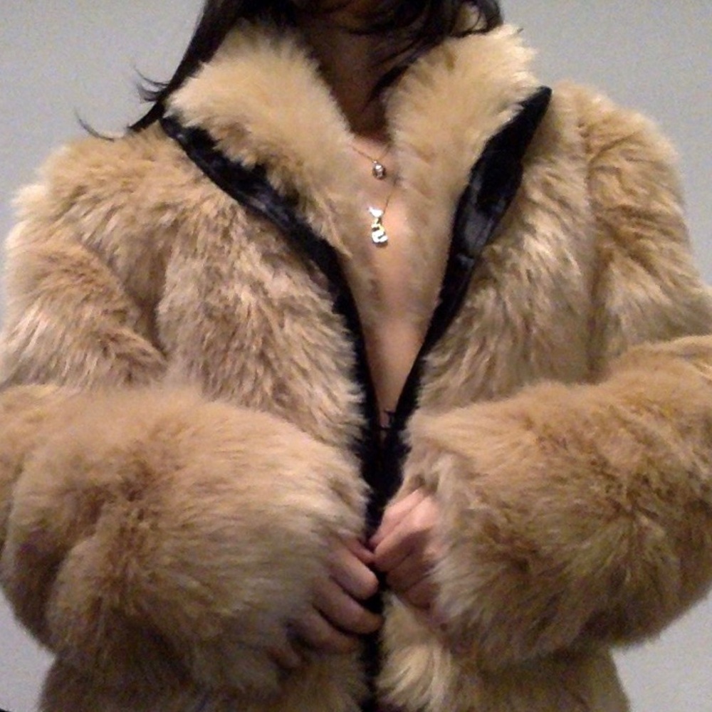 tan faux fur coat with black lining